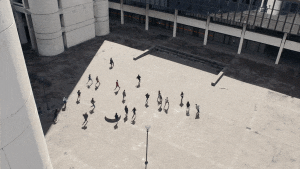 Gif of overhead shot of a piazza from CROWDS with dancers running back and forth, side to side